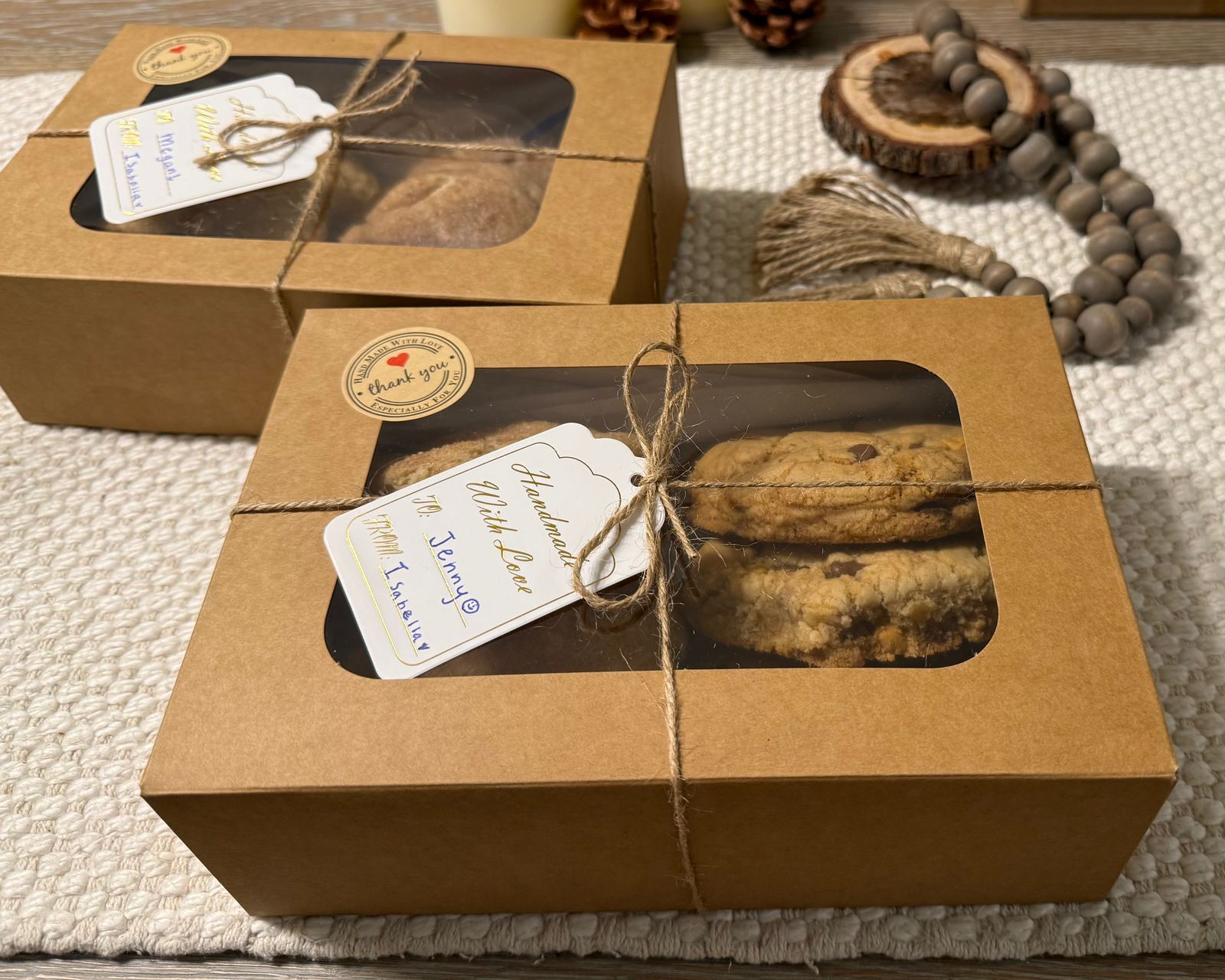 Two kraft window boxes of Three Sisters cookies tied with jute twine, each with a handwritten Handmade With Love tag and a thank-you seal