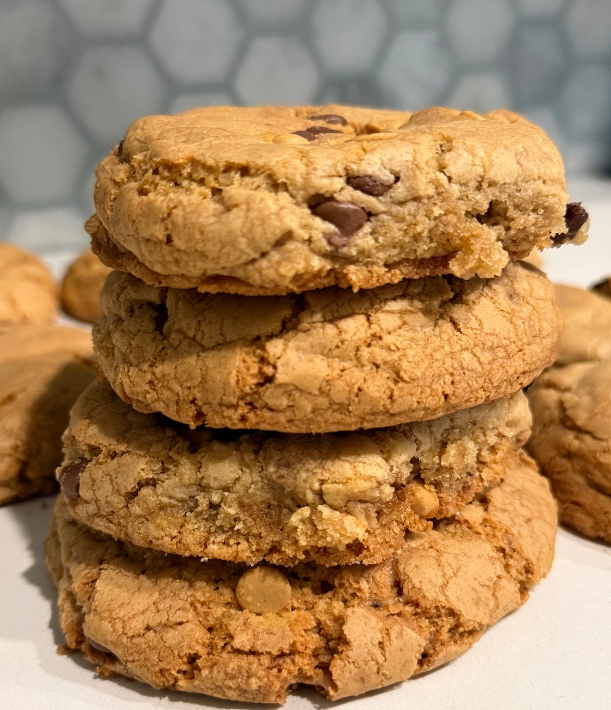 Four Three Sisters Butterscotch Toffee cookies piled high, with butterscotch chips baked in, on the kitchen counter