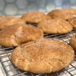 Vegan Snickerdoodles with cinnamon sugar on a cooling rack